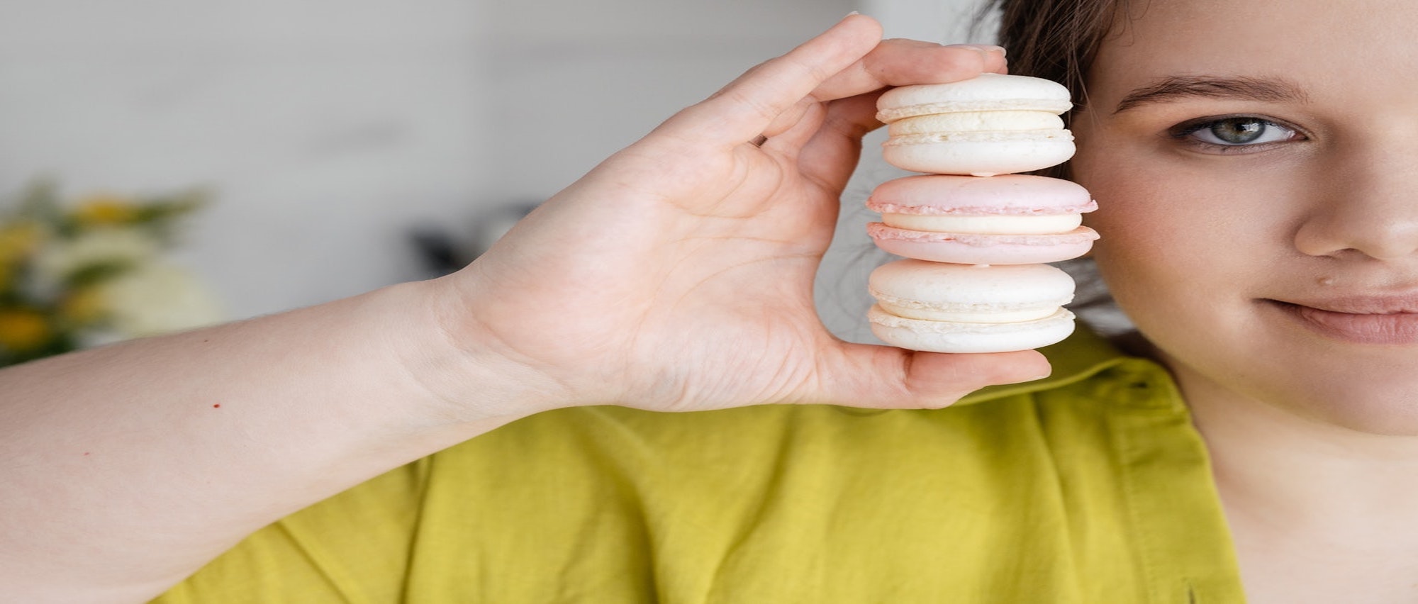 Women holding macroons close to her face