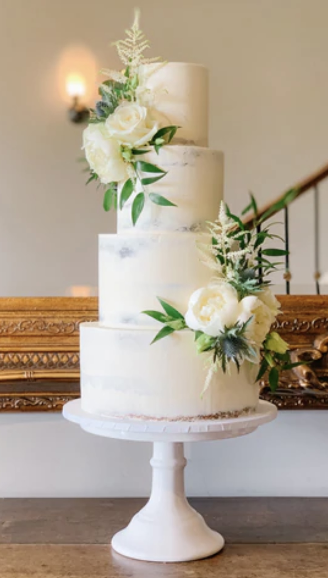 white butter cream cake with white roses 